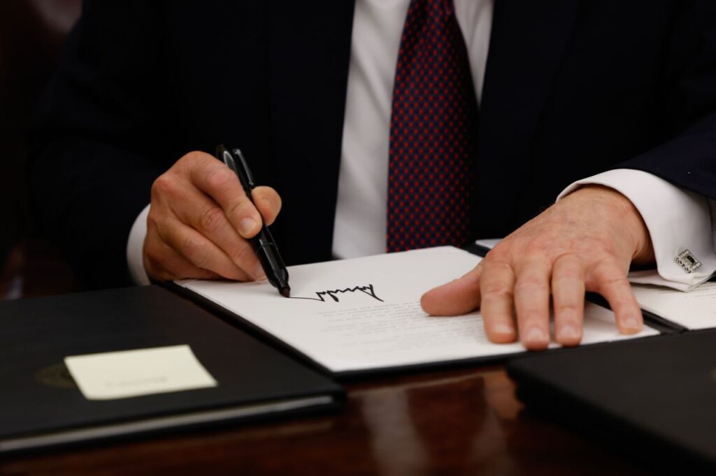 Donald Trump signing the Policy Announcements